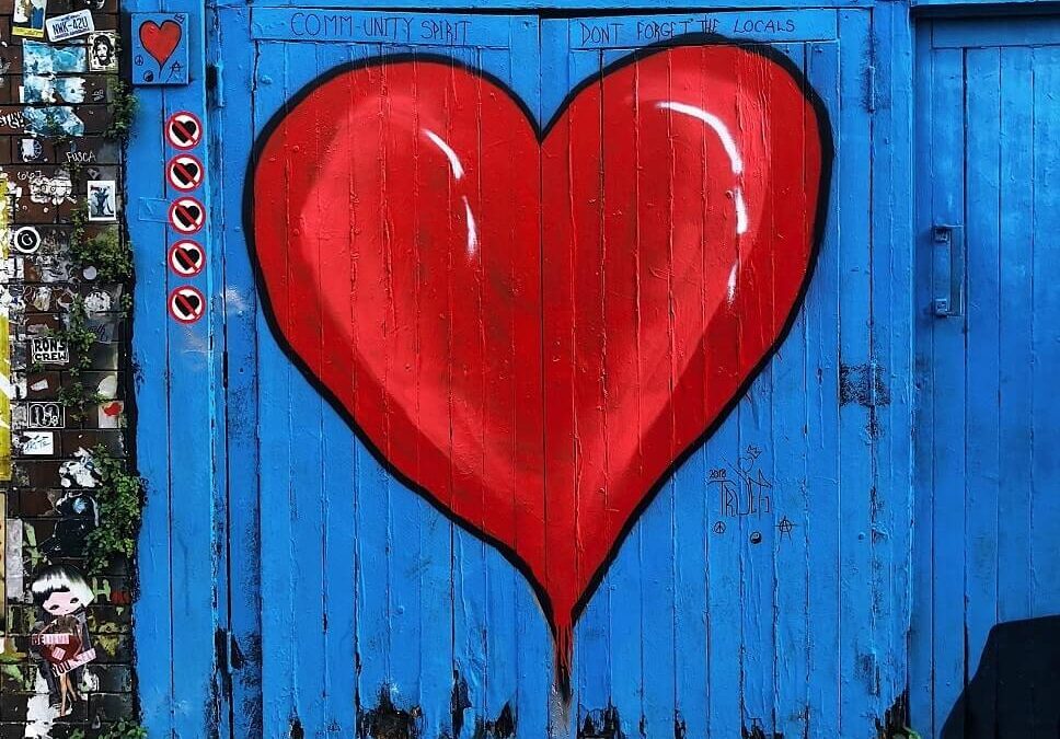 Image, a red heart painted on the blue wooden garage door