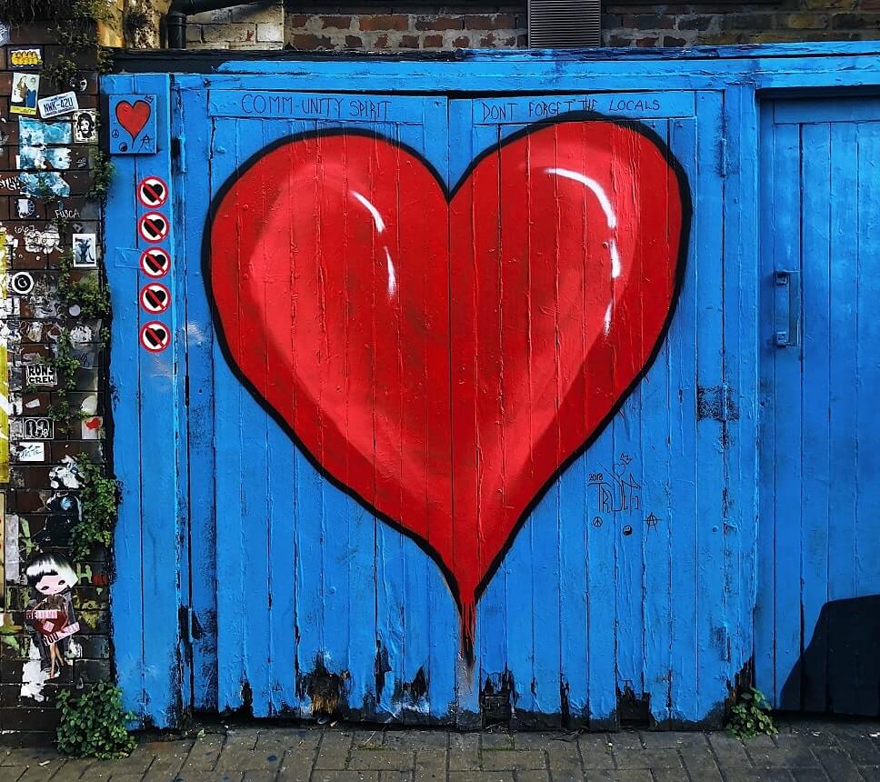 Image, a red heart painted on the blue wooden garage door