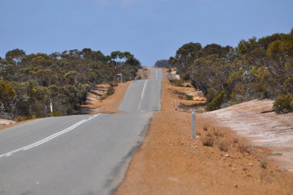 Image, long road in the Australian outback surrounded by bush