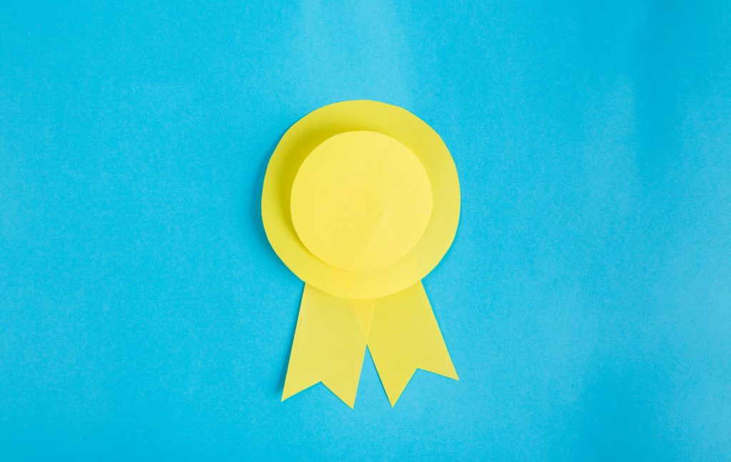 Yellow paper rosette on blue background