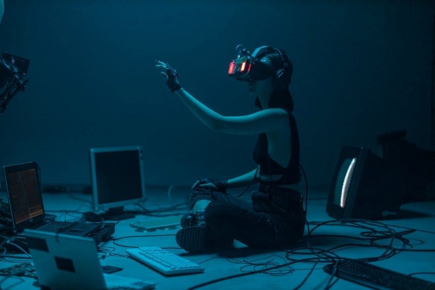 A woman in a tank top using a VR headset.